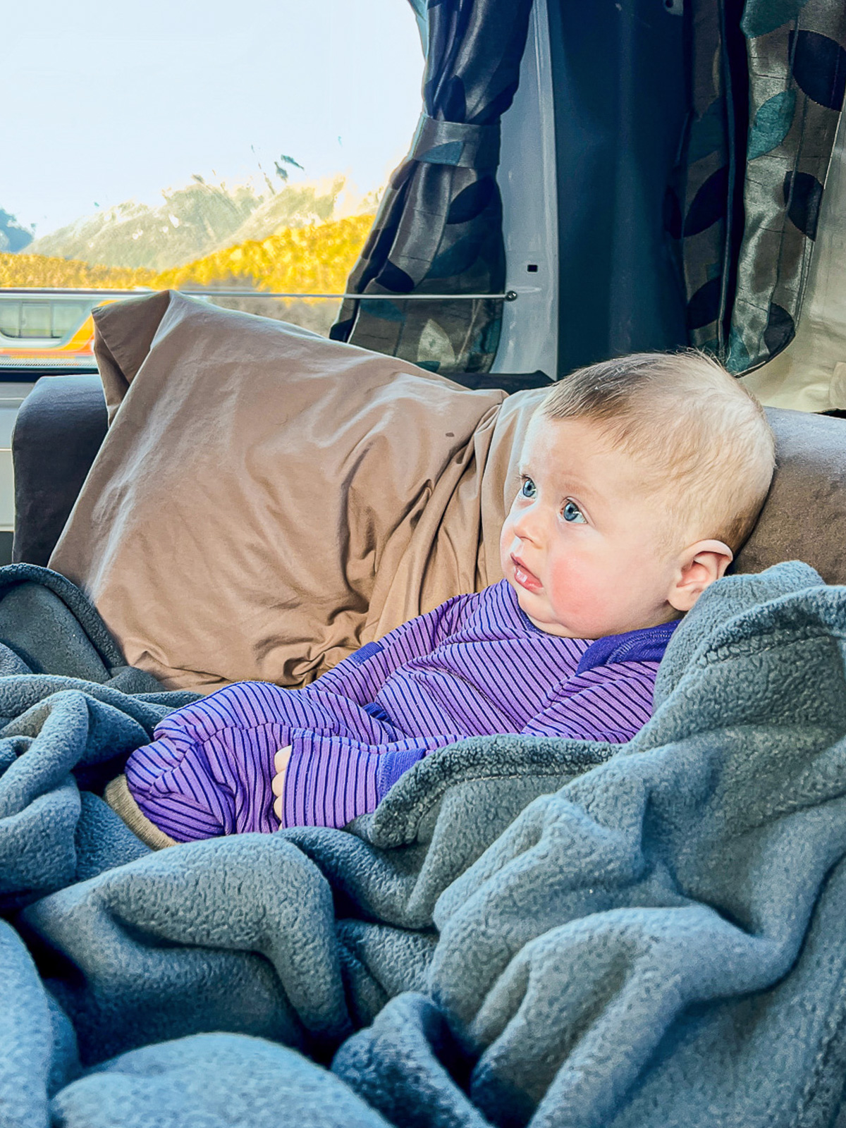 Travel to New Zealand with a Baby: Baby in a Campervan at a campsite outside Milford Sound, New Zealand