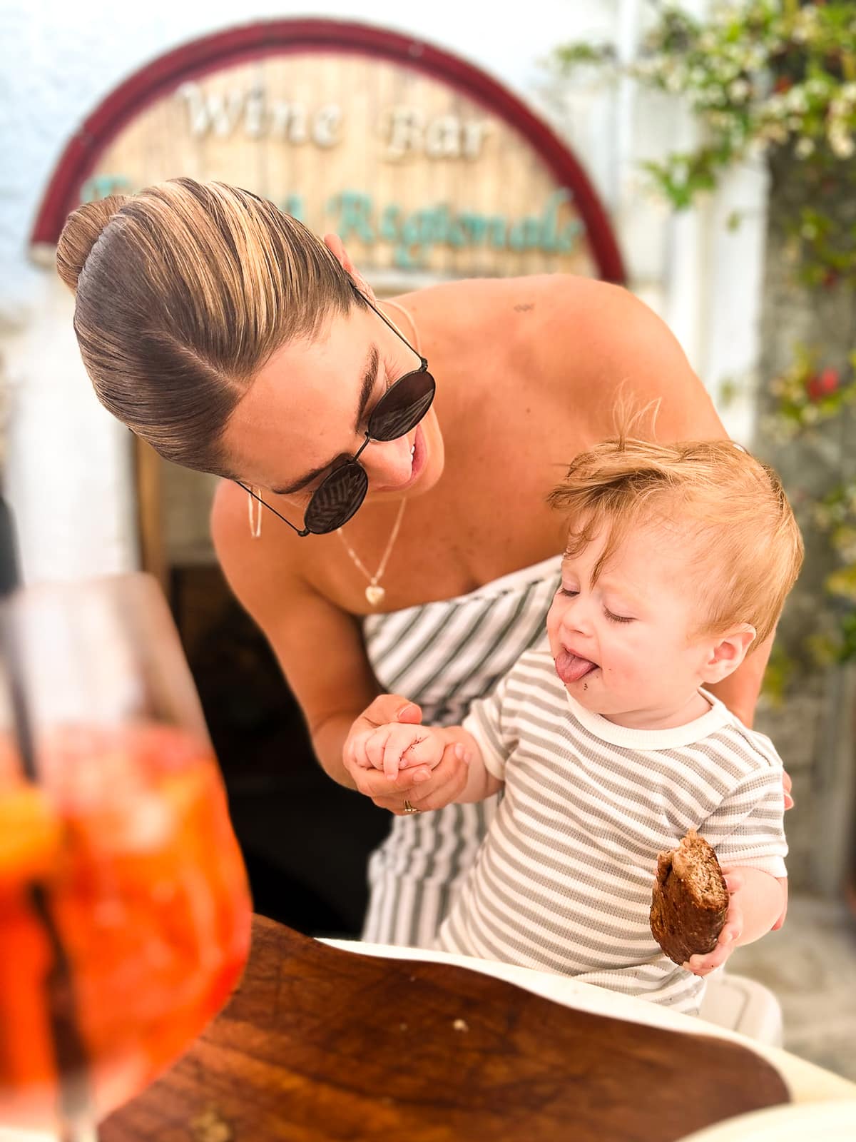 Mom and Baby eating traditional Puglia food Focaccia Bread outside a wine bar in Alberobello, Puglia, Italy