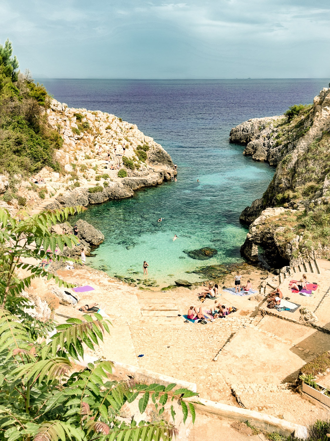 Best Beaches in Puglia: Sunbathing at Cala dell'Acquaviva Beach at the southern part of Puglia, Italy