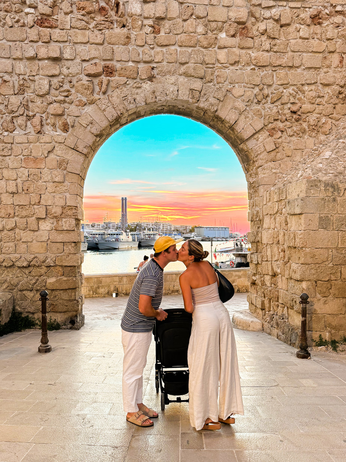 Ultimate Puglia Vacation Guide: Family kissing in front of medieval fortress archway in Monopoli, Puglia, Italy