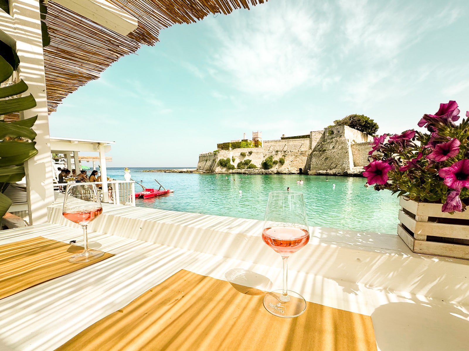 Drinking traditional Puglia, Italy, Rosato wine at Spiaggia di Porto Ghiacciolo Beach bar in Monopoli, Puglia, Italy