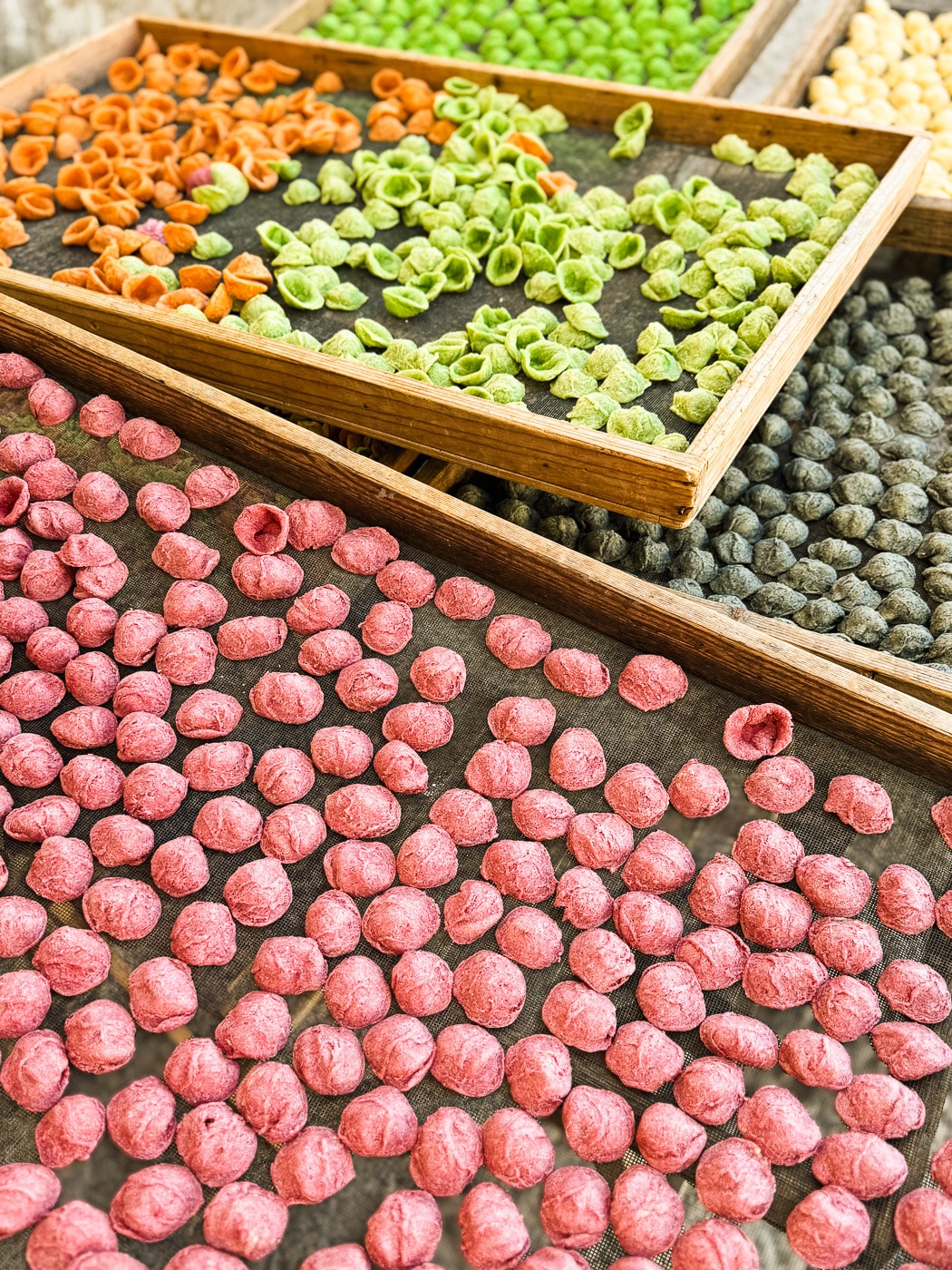 Fresh Orecchiette drying on trays in the streets of Strada Arco Basso in Bari, Puglia