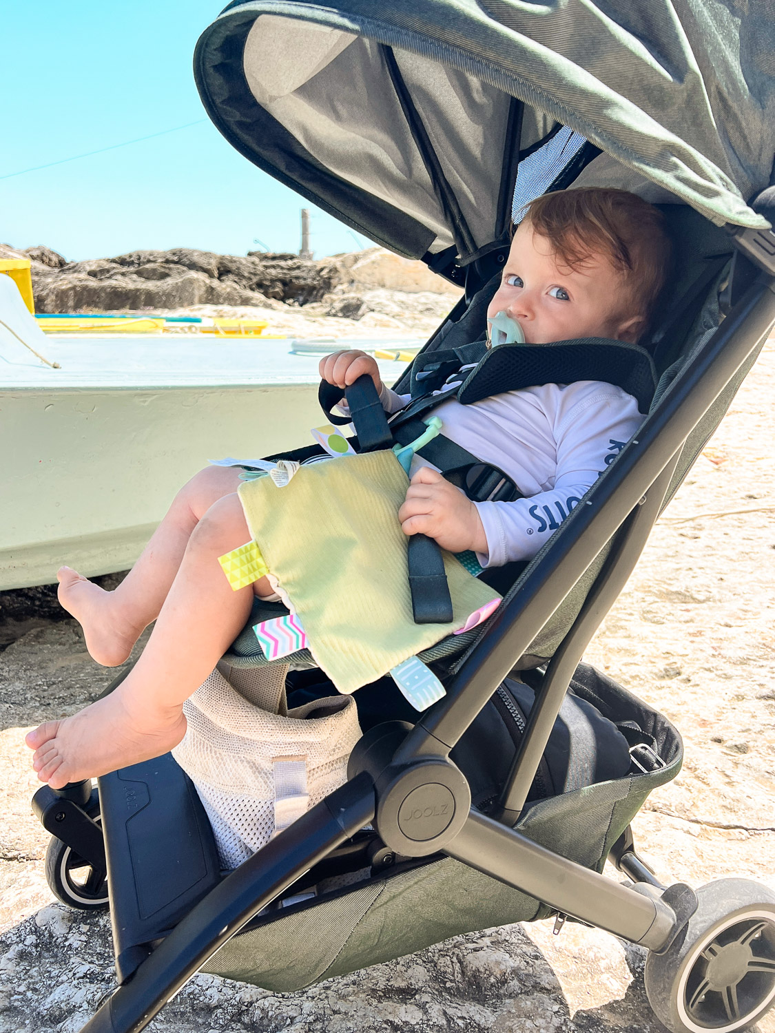 Essential Packing List for Traveling to Europe with a Baby: Baby in Travel Stroller with Store Compartment Underneath in Vieste, Puglia, Italy